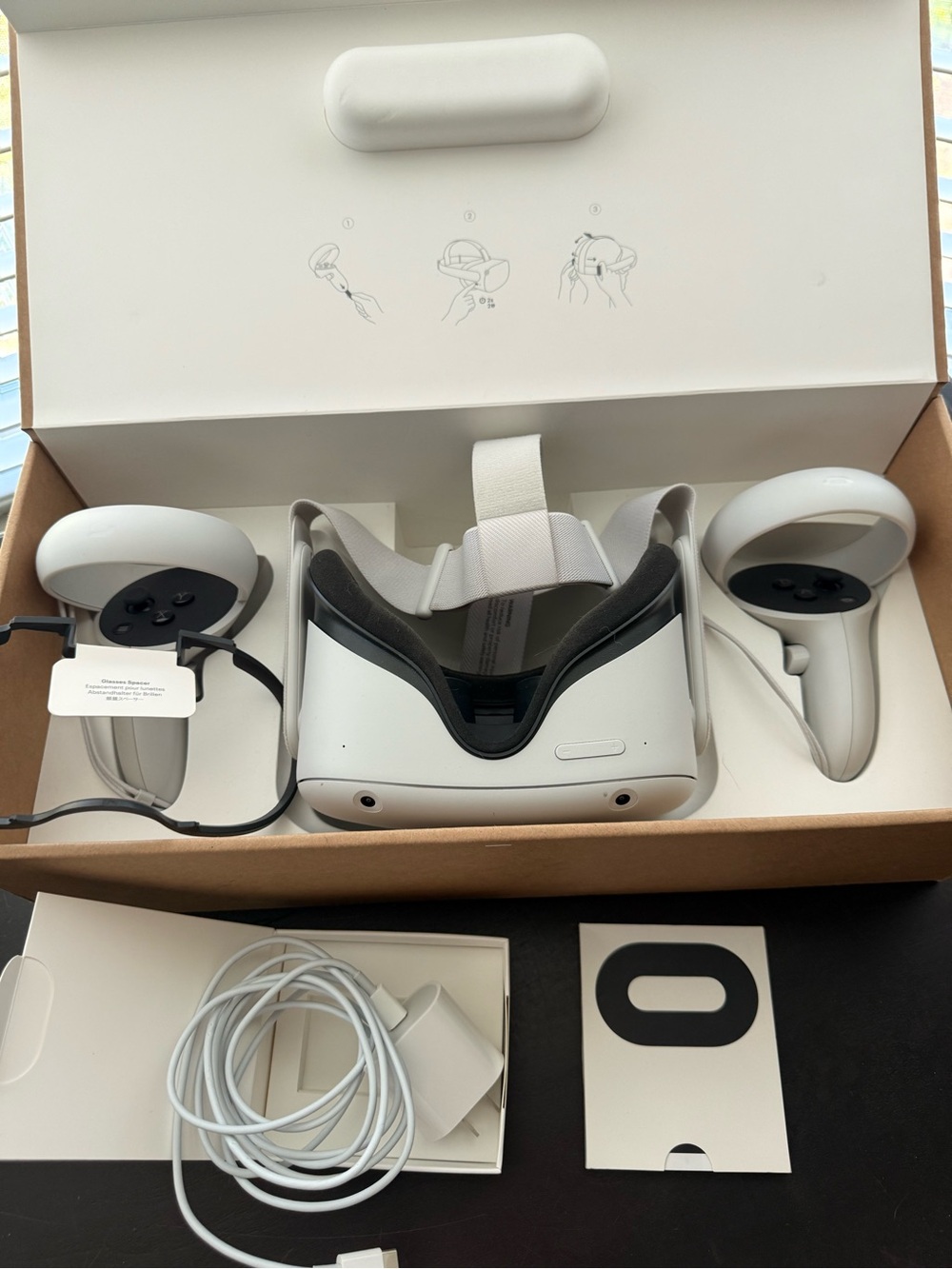 Oculus standalone VR headset with white controllers